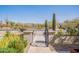 Home's entrance with gated courtyard, desert landscape, and mountain views at 22970 N 79Th Pl, Scottsdale, AZ 85255