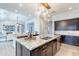 Modern kitchen with granite countertops, stainless steel appliances, and stylish pendant lighting above the island at 22970 N 79Th Pl, Scottsdale, AZ 85255