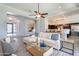 Open concept living area with a plush white sofa, modern furnishings, and seamless flow to the kitchen at 22970 N 79Th Pl, Scottsdale, AZ 85255