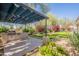 Well-equipped outdoor kitchen area and grill with an adjacent manicured backyard at 22970 N 79Th Pl, Scottsdale, AZ 85255