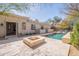 Backyard view of a pool, fire pit, and desert landscaping, offering a relaxing retreat with a touch of luxury at 22970 N 79Th Pl, Scottsdale, AZ 85255