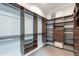 Walk-in closet with custom built-in shelves, drawers, and hanging rods for optimal storage at 22970 N 79Th Pl, Scottsdale, AZ 85255