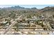 Expansive aerial view showcasing a residential neighborhood nestled against a backdrop of rugged mountains at 2349 E Sahuaro Dr, Phoenix, AZ 85028