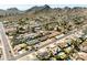 An elevated view shows a well-planned neighborhood featuring homes with pools and desert landscaping against mountain views at 2349 E Sahuaro Dr, Phoenix, AZ 85028