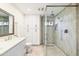 Modern bathroom featuring quartz countertops, glass shower, and custom storage cabinets at 2349 E Sahuaro Dr, Phoenix, AZ 85028