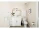 Bright bathroom with a large vanity, framed mirror, and white toilet at 2349 E Sahuaro Dr, Phoenix, AZ 85028