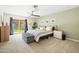 Airy bedroom with ceiling fan, natural light, a sliding door, and an ensuite bathroom at 2349 E Sahuaro Dr, Phoenix, AZ 85028