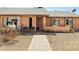 Inviting front entrance with brick walkway, gravel landscaping and decorative chairs at 2349 E Sahuaro Dr, Phoenix, AZ 85028