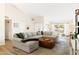 Bright living room featuring a large sectional sofa, wood floors, and vaulted ceiling at 2349 E Sahuaro Dr, Phoenix, AZ 85028