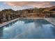 A large community pool with mountain views and desert landscaping offers a luxurious outdoor experience at 23750 N 126Th Pl, Scottsdale, AZ 85255