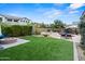 Manicured backyard featuring a cozy fire pit, green artificial turf, and a full outdoor seating area at 2454 E Ebony Dr, Chandler, AZ 85286