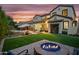 Twilight view of the backyard showcasing a fire pit, artificial turf, and a well-maintained outdoor living area at 2454 E Ebony Dr, Chandler, AZ 85286