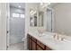 Double sink bathroom with white counter, dark wood cabinets, gold fixtures, and a tub and shower combo at 2454 E Ebony Dr, Chandler, AZ 85286