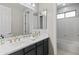 Bright bathroom features a double sink with black cabinets, gold fixtures and a tub and shower combo at 2454 E Ebony Dr, Chandler, AZ 85286