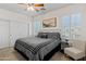 Well-lit bedroom with a large bed, modern gray bedding, shutters on the windows, and a ceiling fan at 2454 E Ebony Dr, Chandler, AZ 85286