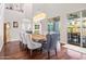 Bright dining room with hardwood floors, large dining table and modern light fixture at 2454 E Ebony Dr, Chandler, AZ 85286