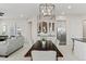 Open dining area with modern chandelier, seamlessly connected to the living room and kitchen, perfect for entertaining at 2454 E Ebony Dr, Chandler, AZ 85286