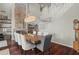 Dining area with a modern light fixture and brick fireplace, seating for eight at 2454 E Ebony Dr, Chandler, AZ 85286