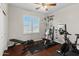 Well-lit home gym featuring modern exercise equipment and sleek hardwood floors at 2454 E Ebony Dr, Chandler, AZ 85286