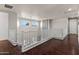 Second floor hallway features hardwood floors, staircase, and charming stone accent wall at 2454 E Ebony Dr, Chandler, AZ 85286