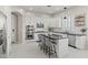 Modern kitchen with white cabinets, stainless steel appliances, an island with bar seating, and abundant natural light at 2454 E Ebony Dr, Chandler, AZ 85286