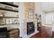 Cozy living room with stone fireplace and hardwood floors at 2454 E Ebony Dr, Chandler, AZ 85286