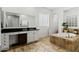 Spacious main bathroom showcases a luxurious soaking tub, tile flooring, and white cabinets at 2454 E Ebony Dr, Chandler, AZ 85286