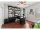 Bright office space with desk, shelves, wood floor and plantation shutters on the windows at 2454 E Ebony Dr, Chandler, AZ 85286