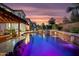 Beautiful backyard pool with a rock waterfall feature and seating at the swim-up bar at 2454 E Ebony Dr, Chandler, AZ 85286