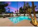 The backyard pool features a luxurious sitting area and a sun umbrella, perfect for relaxing by the water at 25 W Frier Dr, Phoenix, AZ 85021