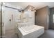 Modern bathroom with separate shower and tub, complemented by a sleek design and stylish fixtures at 25 W Frier Dr, Phoenix, AZ 85021