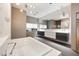 Modern bathroom featuring a large soaking tub, dual vanity, and contemporary lighting fixtures at 25 W Frier Dr, Phoenix, AZ 85021