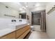 Bathroom featuring contemporary fixtures, a sleek vanity, and tiled shower at 25 W Frier Dr, Phoenix, AZ 85021