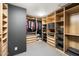 Walk-in closet with custom wood shelving, drawers, and ample storage space at 25 W Frier Dr, Phoenix, AZ 85021