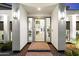 Welcoming entryway with modern lighting, and a glimpse of the home's elegant interior at 25 W Frier Dr, Phoenix, AZ 85021