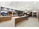 Modern kitchen boasting wood cabinets, a spacious island with seating, and views of the backyard at 25 W Frier Dr, Phoenix, AZ 85021