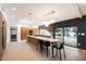 Modern kitchen with sleek countertops, stainless steel appliances, and a view of the backyard pool at 25 W Frier Dr, Phoenix, AZ 85021