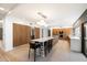 Bright and airy kitchen with an oversized island, custom wood cabinets, and modern appliances at 25 W Frier Dr, Phoenix, AZ 85021