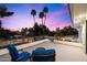 Outdoor rooftop patio at dusk, with comfortable blue seating and lush landscaping at 25 W Frier Dr, Phoenix, AZ 85021