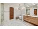 Bright bathroom featuring marble floors, soaking tub, walk-in shower, and wood cabinets at 25436 N 114Th St, Scottsdale, AZ 85255