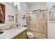 Bathroom with stylish vanity, tiled shower, and unique wall art at 25436 N 114Th St, Scottsdale, AZ 85255