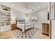 Bedroom with wood floors, ceiling fan, white walls, and shelf display at 25436 N 114Th St, Scottsdale, AZ 85255