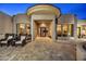 Inviting front entrance with stone walkway and seating area, showcasing the home's unique architectural details at 25436 N 114Th St, Scottsdale, AZ 85255