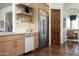 Modern kitchen featuring stainless steel appliances, custom cabinetry, and a view into the dining area at 25436 N 114Th St, Scottsdale, AZ 85255