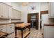 Bright laundry room with custom cabinets, butcher block countertops, decorative tile floors, and convenient washer and dryer at 25436 N 114Th St, Scottsdale, AZ 85255