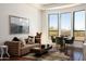 Stylish living room with a modern sofa, unique artwork, and large windows offering scenic views at 25436 N 114Th St, Scottsdale, AZ 85255