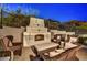 Outdoor fireplace with seating area for entertaining at 25436 N 114Th St, Scottsdale, AZ 85255