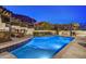 Sparkling pool with stone accents, comfortable seating, and an outdoor kitchen, perfect for relaxing and entertaining at 25436 N 114Th St, Scottsdale, AZ 85255