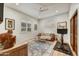 Cozy sitting room with leather couch, wood accents, and lots of natural light at 25436 N 114Th St, Scottsdale, AZ 85255