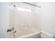 Tiled bathtub with shower and window for natural light in the bathroom at 2803 W Angela Dr, Phoenix, AZ 85053